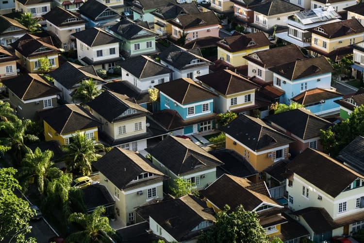 a row of houses with solar on there roofs Image