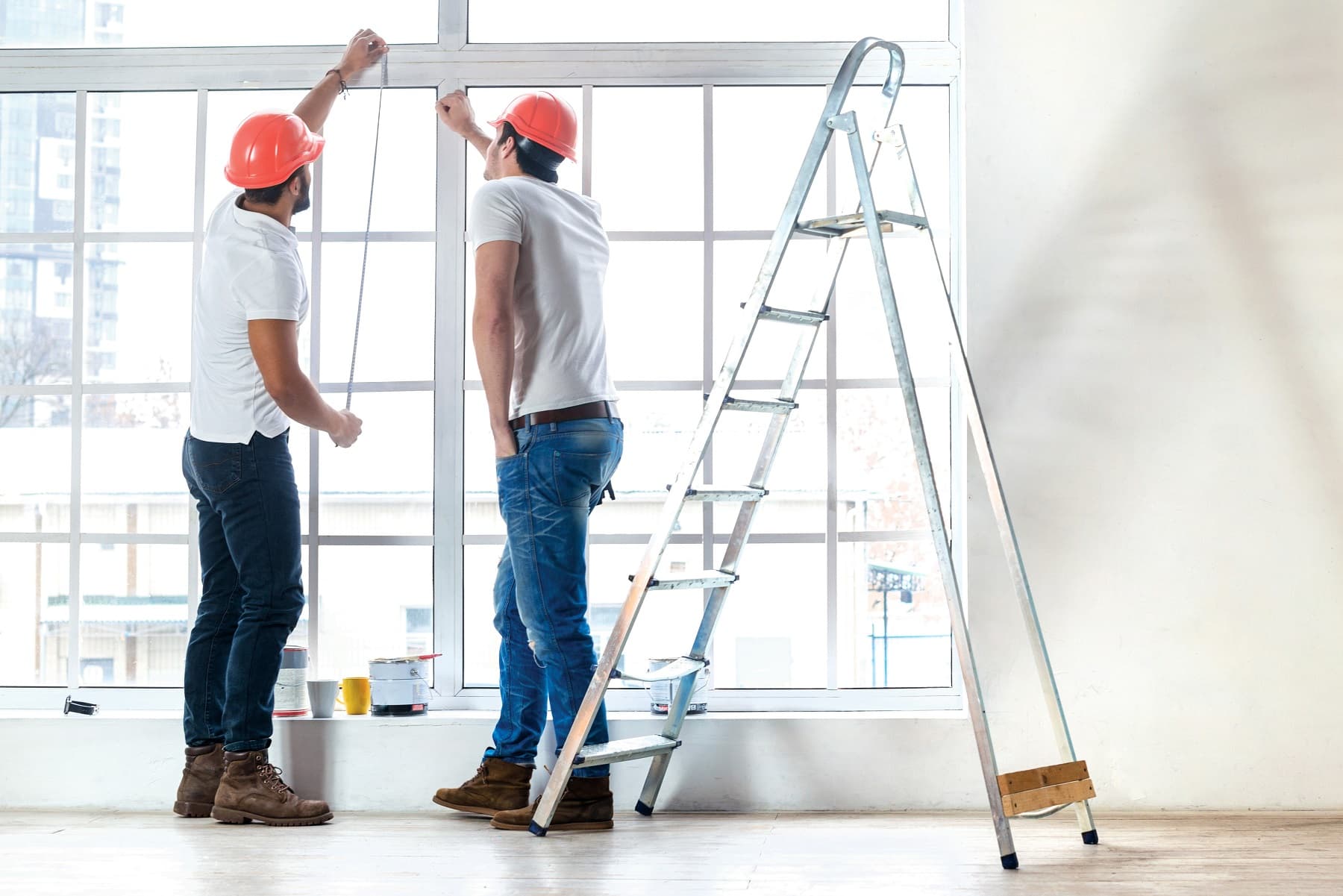 Two men worker measuring the windows on a house Image